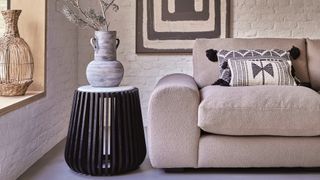 Japandi living room styled with curved sofa and round side table to embrace soft edged furniture