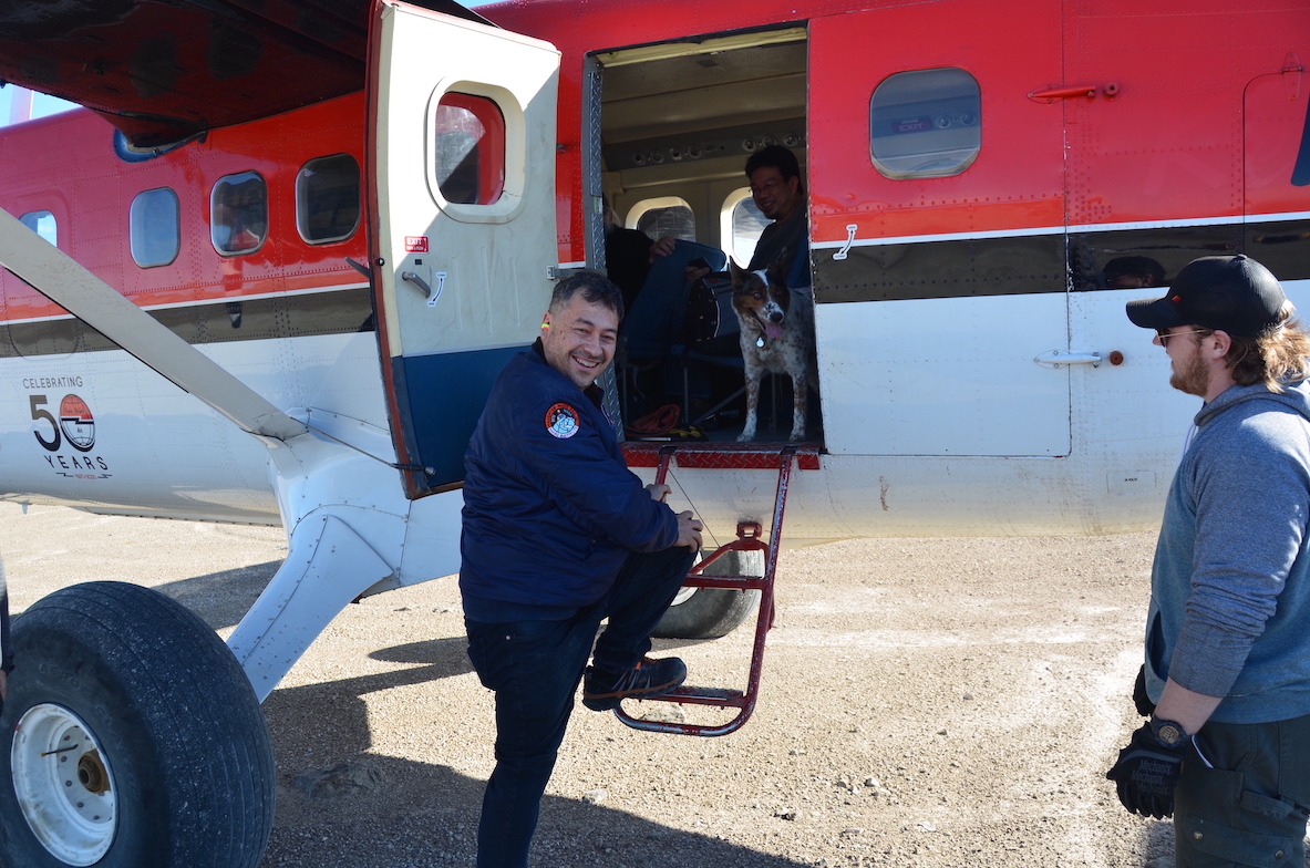 A smiling Pascal Lee steps off of an airplane.