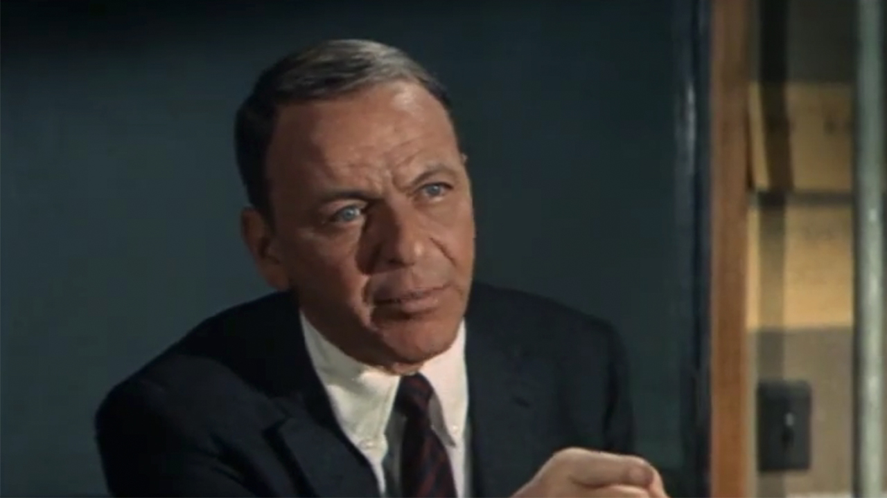 A close up of Frank Sinatra in a coat and tie in The Detective