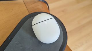 The Google Pixel Buds Pro charging case on a wireless charging pad