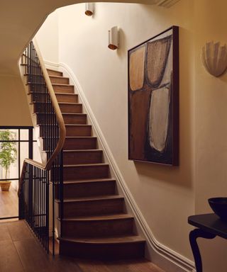 Warm neutral entryway with wooden staircase