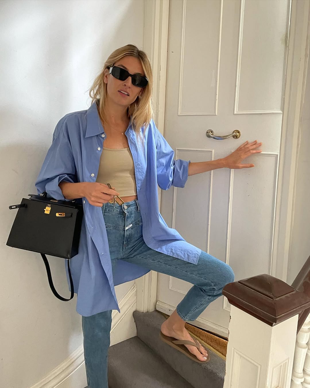 woman wearing slim jeans with oversized button down shirt