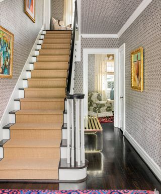 Entryway and stairs with black and white wallpaper