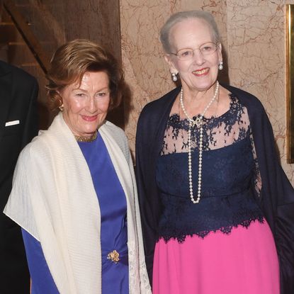 Queen Margrethe and Queen Sonja posing together and smiling