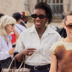 nikki ogunnaike wearing a short-sleeved button-down shirt and sunglasses 