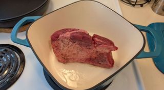 Searing meat in a blue Dutch oven