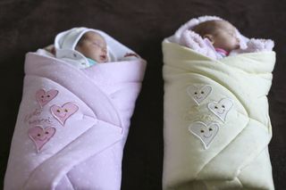 Twin babies in blankets.