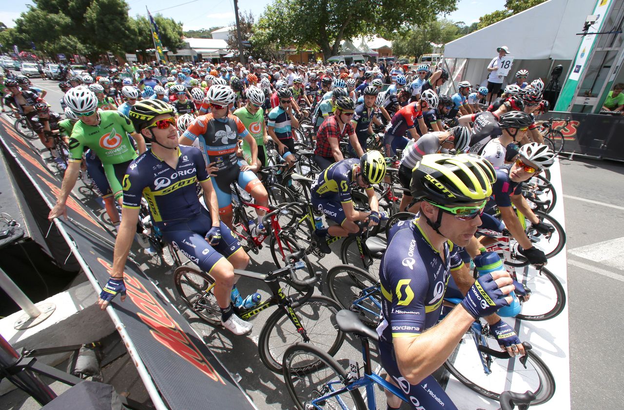 The riders pass through the finish line for another lap