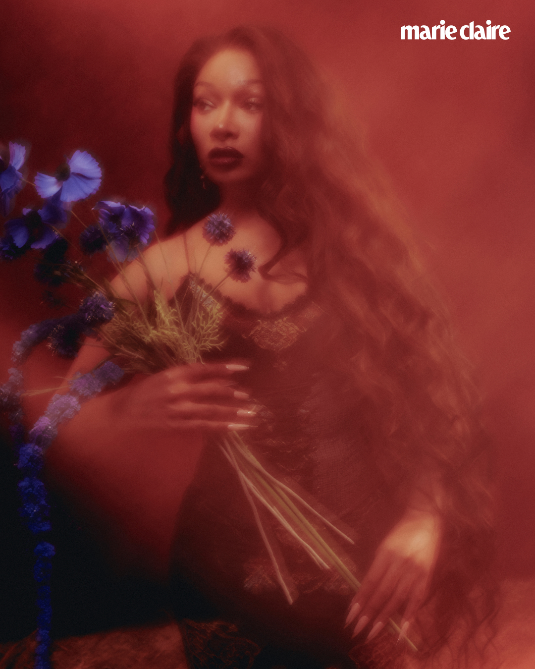 Megan Thee Stallion poses for Marie Claire holding purple flowers