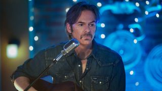 Billy Burke playing the guitar on Fire Country.