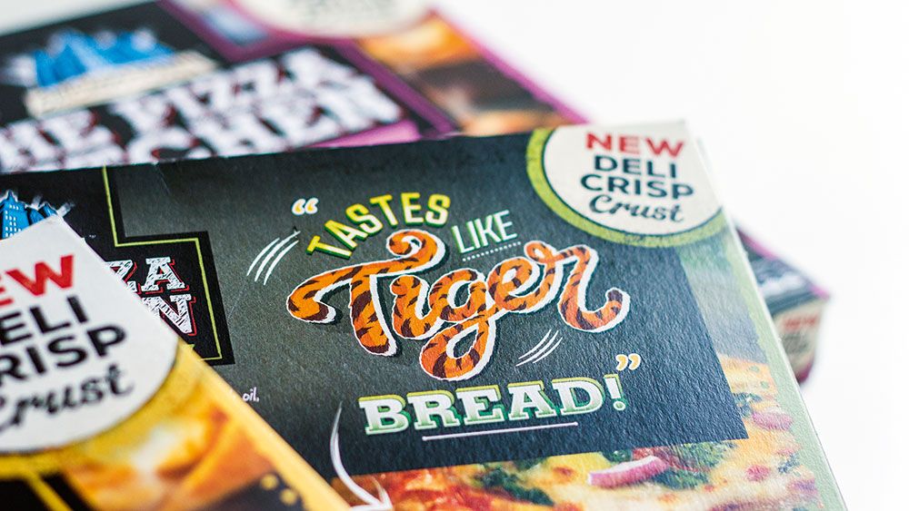 Pizza Kitchen packaging with fun illustrated statement &quot;Tastes like tiger bread&quot;