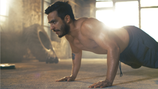 Man doing tabata-style hiit workout, performing the push up