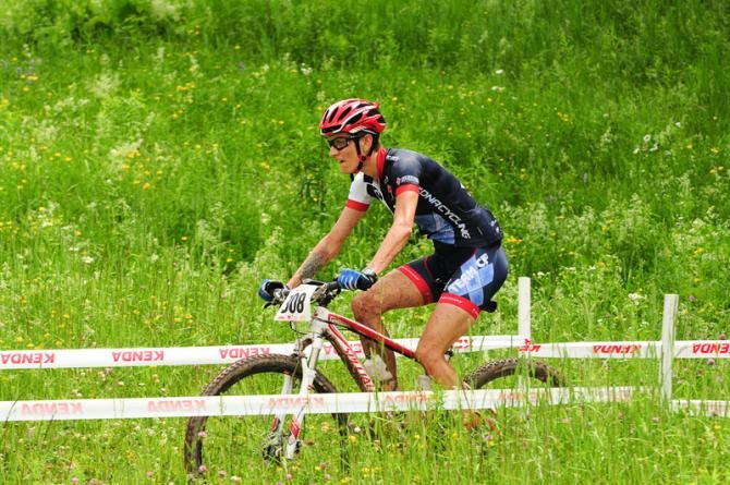 Niclole Thiemann riding through tall grass and flowers