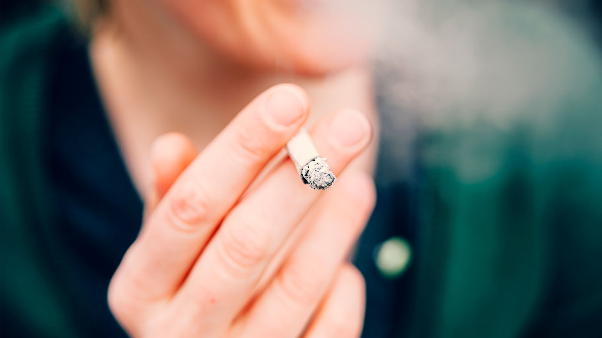 close up of a person smoking a cigarette