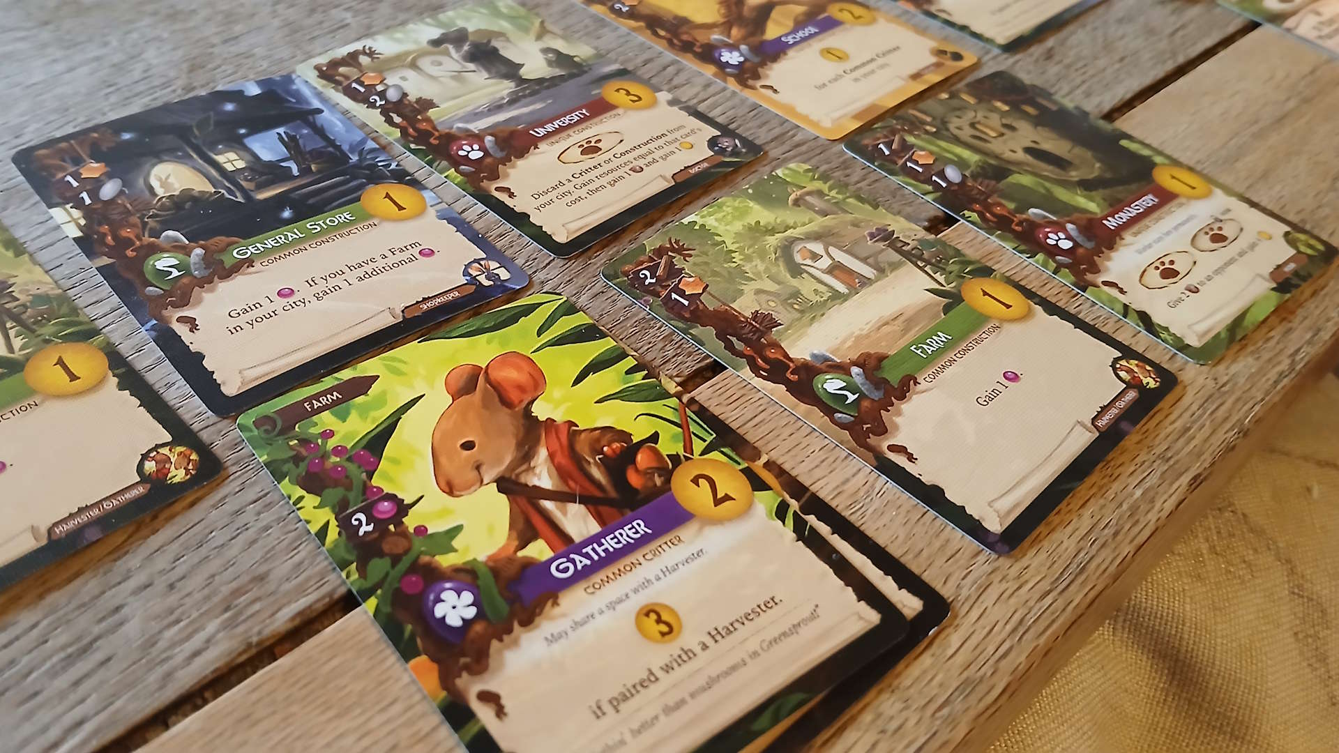 Everdell cards laid out on a wooden surface