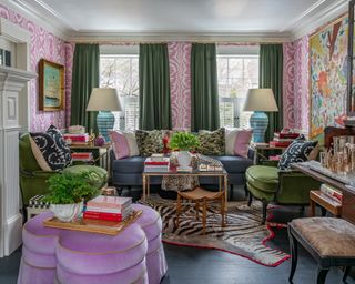 Formal living room ideas with pink and white patterned wallpaper, green curtains, blue sofa, green armchairs and lavender ottoman