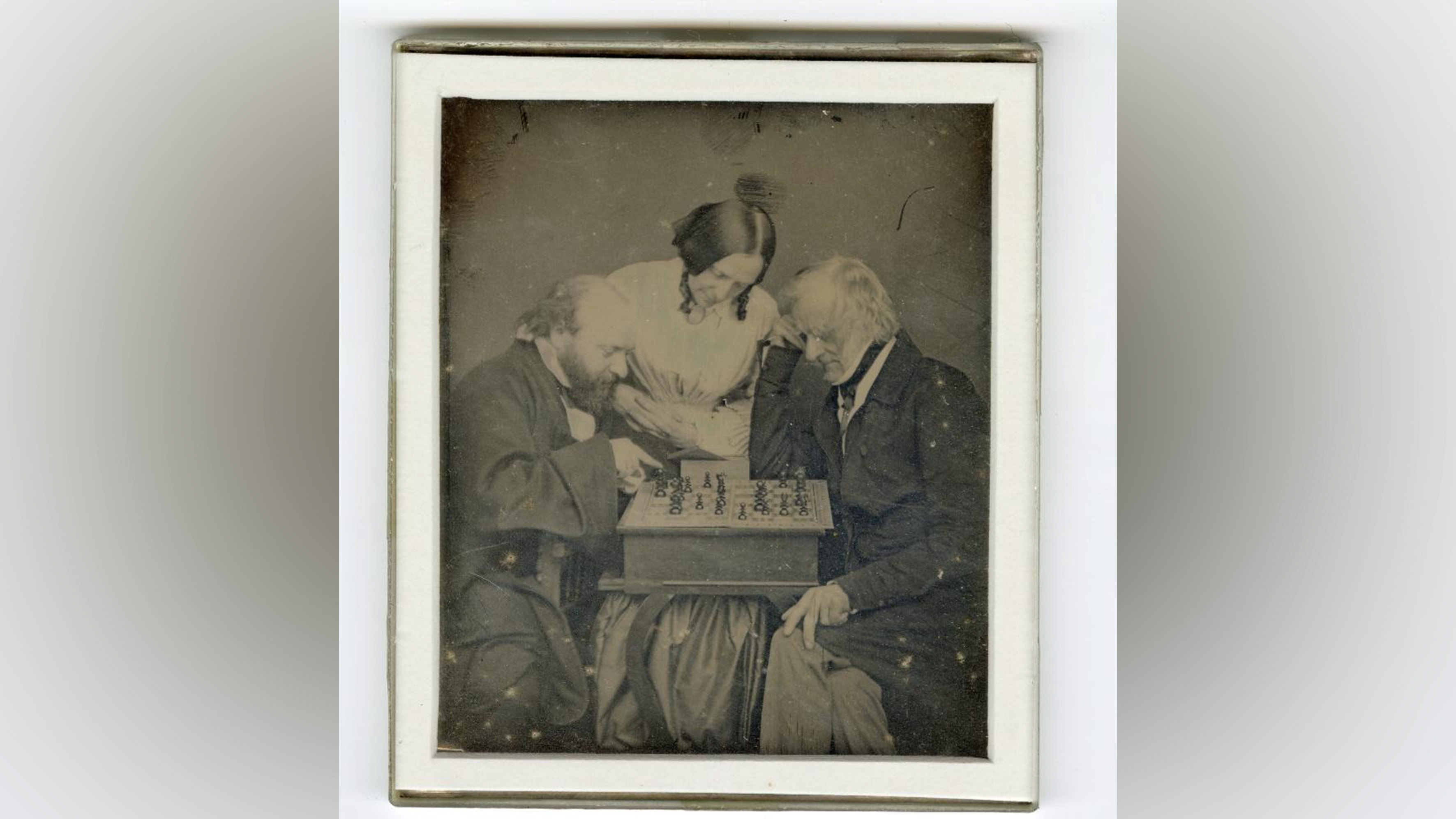 Three people playing chess.