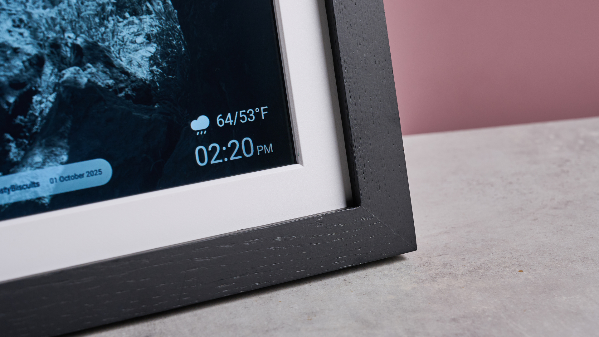 A closeup of the lower right corner of the Eptusmey 10.1-inch WiFi Digital Photo Frame, showing the temperature and time.