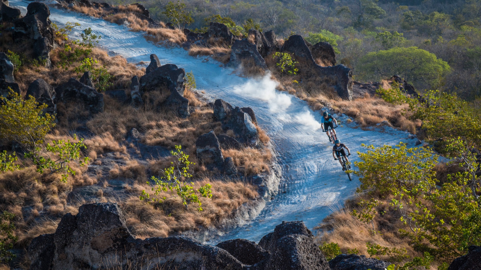 Mountain bikers race down a trail at Rio Perdido in Costa Rica