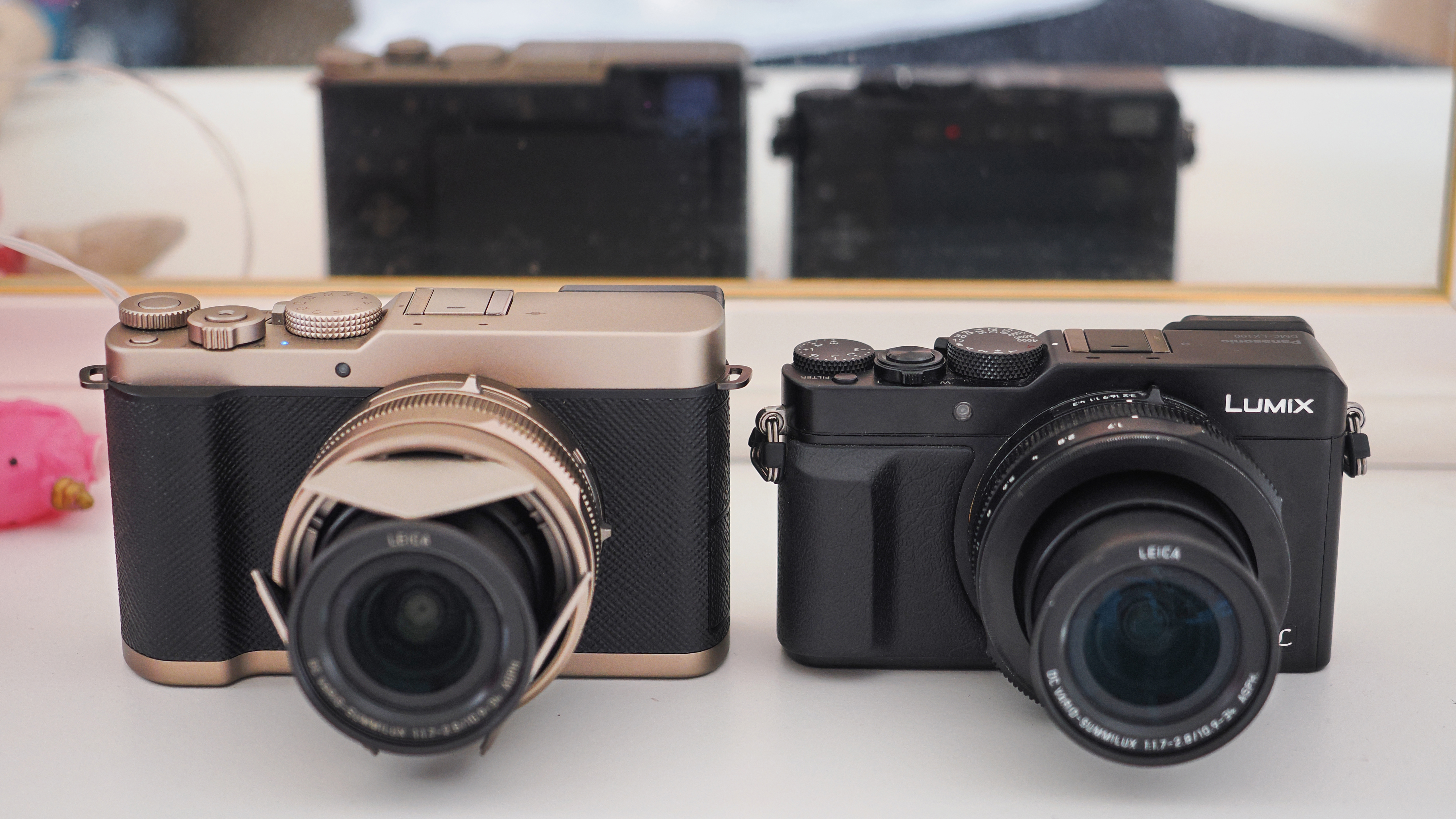 Panasonic Lumix L10 next to a Panasonic Lumix LX100