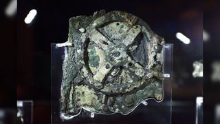 A picture taken at the Archaeological Museum in Athens on September 14, 2014 shows a piece of the Antikythera Mechanism, a 2nd-century B.C. device known as the world's oldest computer which tracked astronomical phenomena and the cycles of the Solar System. Here we see what looks like a large gear.