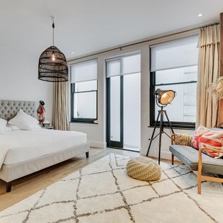 bedroom with white wall bed with white cushion and window