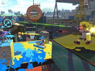A screenshot from Splatoon 2, showing players spreading ink over the arena with rollers, rifles and other weaponry