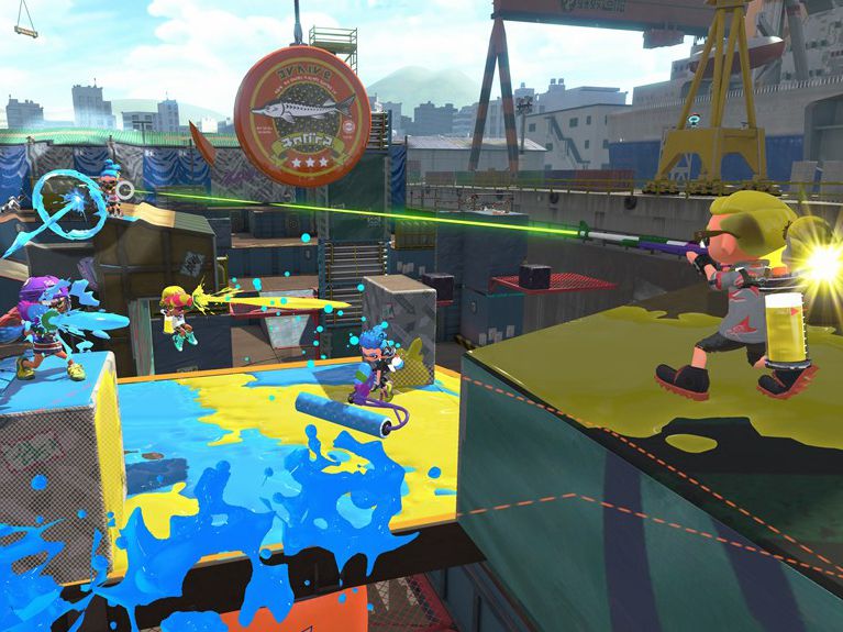 A screenshot from Splatoon 2, showing players spreading ink over the arena with rollers, rifles and other weaponry