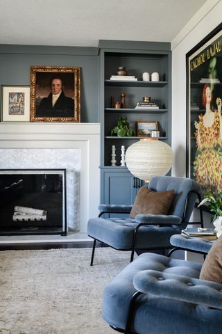 A blue painted living room with blue sofas painted in farrow and ball de nimes