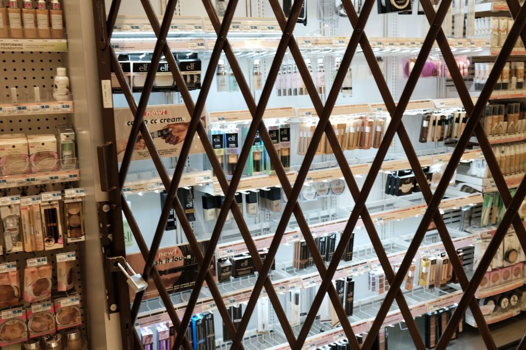 A gate is used to lock items at a pharmacy and convenience store in New York City. 