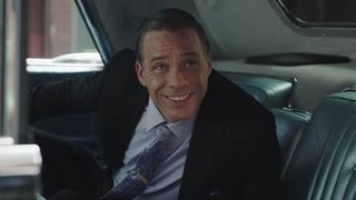 Michael Raymond-James as Joe Colombo smiling in a car in Godfather of Harlem