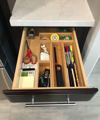 tidy drawer with wooden drawer organizers separating stationery items