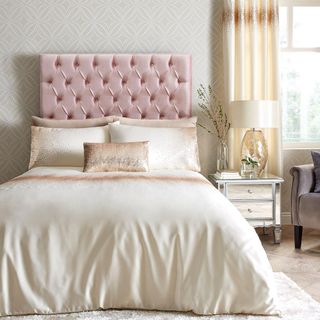 bedroom with ombre bedding and pink buttoned headboard