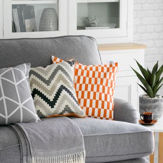 grey living room with sofa and decorative cushions
