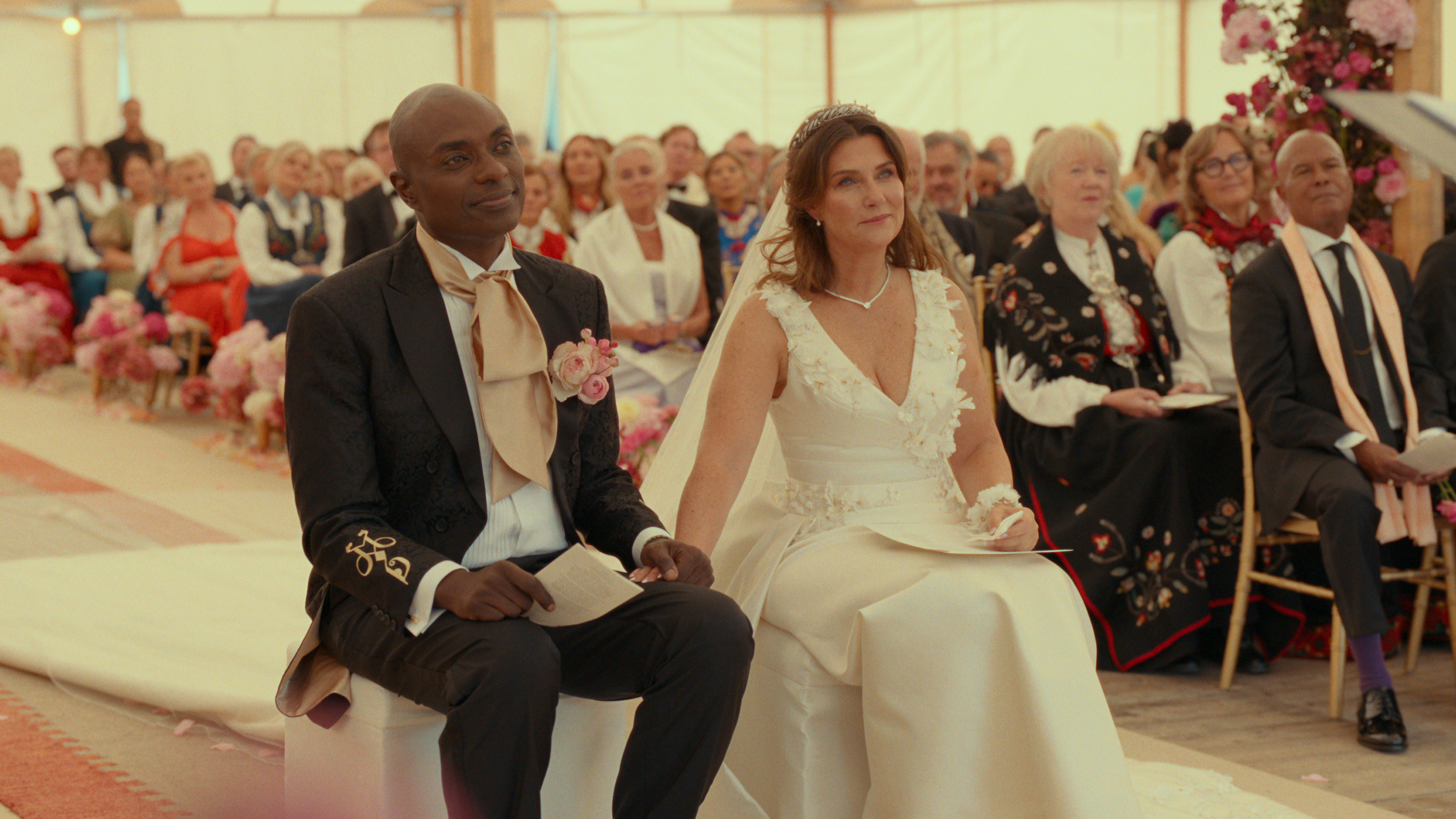 Princess Martha Louise and Durek Verrett holding hands sitting in chairs during their wedding ceremony