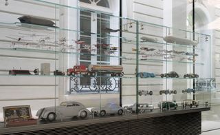 Glass cabinets with models of different types of transportation