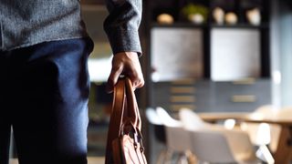 Gen Z worker with satchel pictured returning to the office. 