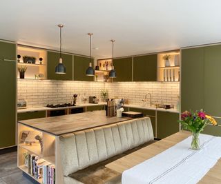 kitchen diner with green units and open shelved areas with LED lighting