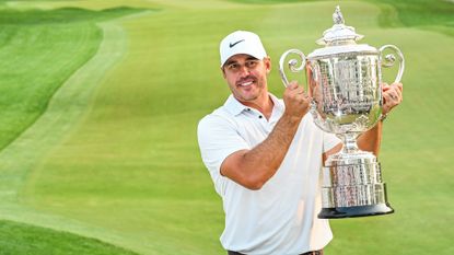 Brooks Koepka smiles with the Wanamaker Trophy following his two stroke victory in the final round of the 2023 PGA Championship at Oak Hill Country Club on May 21, 2023.
