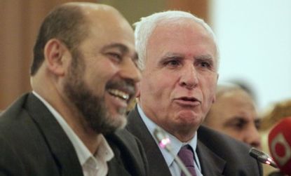 Leaders of the rival Palestinian movements, Azzam al Ahmad of Fatah (left) and Mousa Abu Marzook of Hamas inked a deal Wednesday to end their long-running bitter feud.