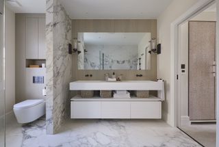 marble bathroom with fluted cabinets
