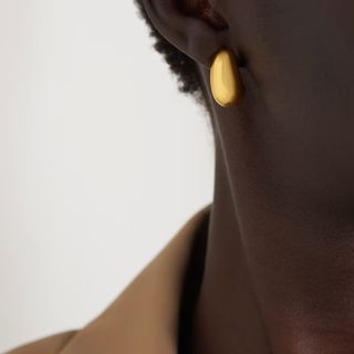 jewellery gifts woman wearing gold drop hoop earrings