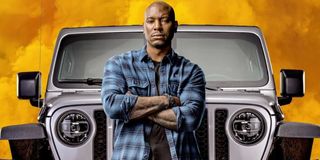 F9 Tyrese Gibson poses in front of a Jeep and some fire