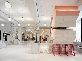 Interior view of Selfridges art block series, white gloss flooor, marble columns, white ceiling with lights, white counter tops