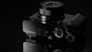 The Fujifilm GFX100RF Fragment Edition on a black background