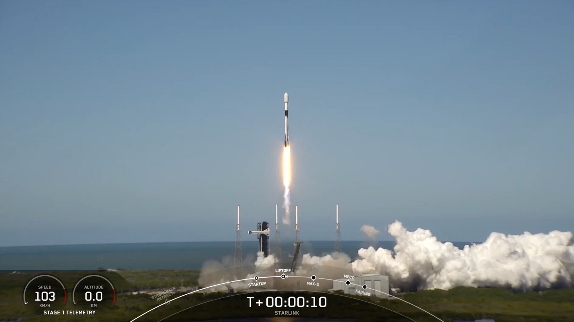 a black-and-white spacex falcon 9 rocket launches into a blue sky.