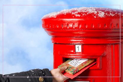 Christmas cards being put in a post box with snow on top