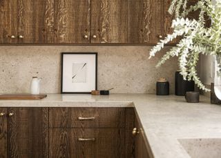 A kitchen with dark wood kitchen cabinets