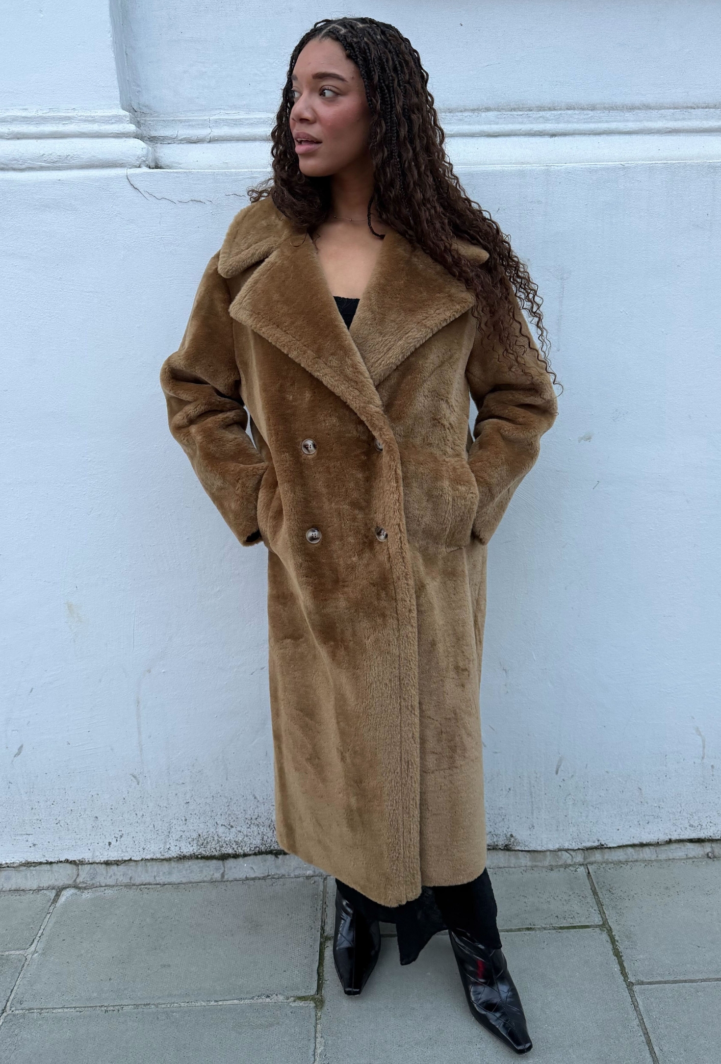 An editor from Who What Wear UK modelling a teddy coat.