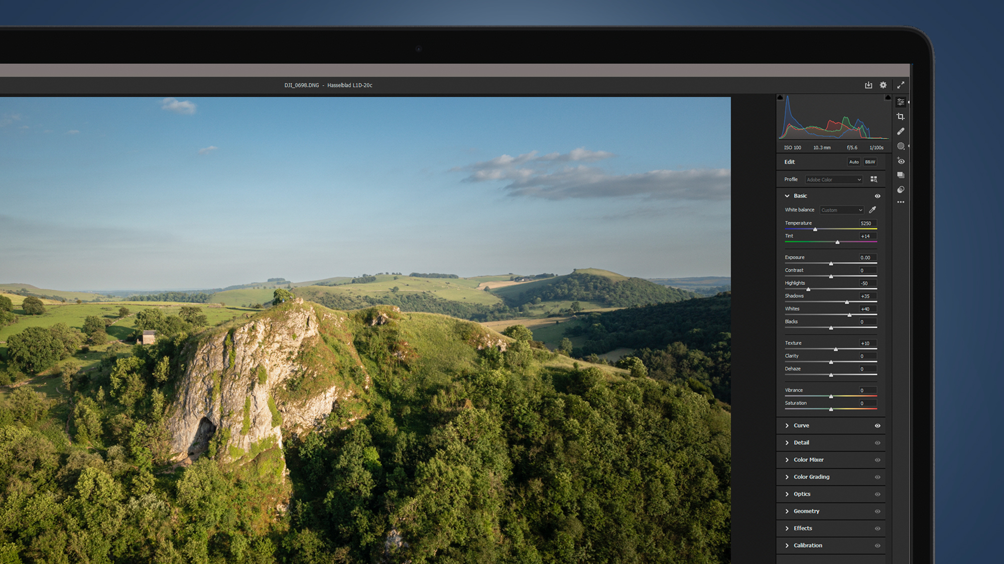 An aerial photo being processed in Lightroom on a laptop